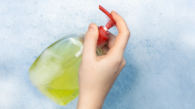 woman washes with liquid soap