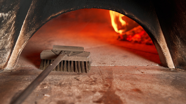 brushing wood fire pizza oven