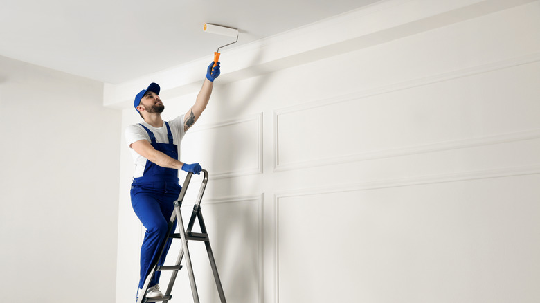 man painting ceiling