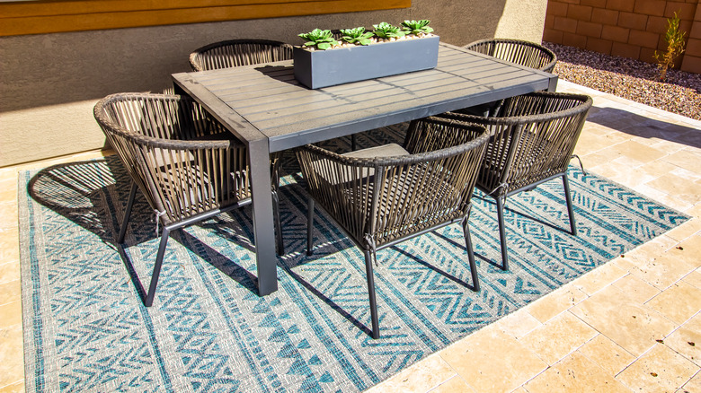 blue rug under outdoor table