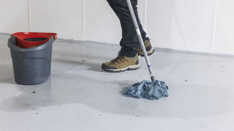 Person mopping concrete