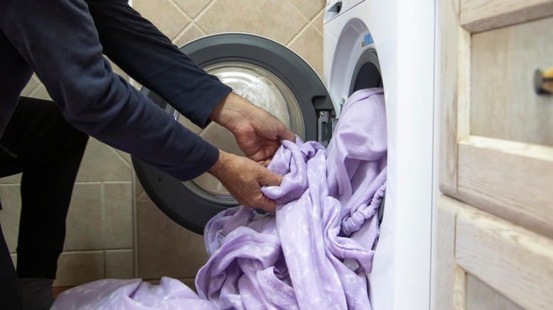 Putting sheets into the dryer