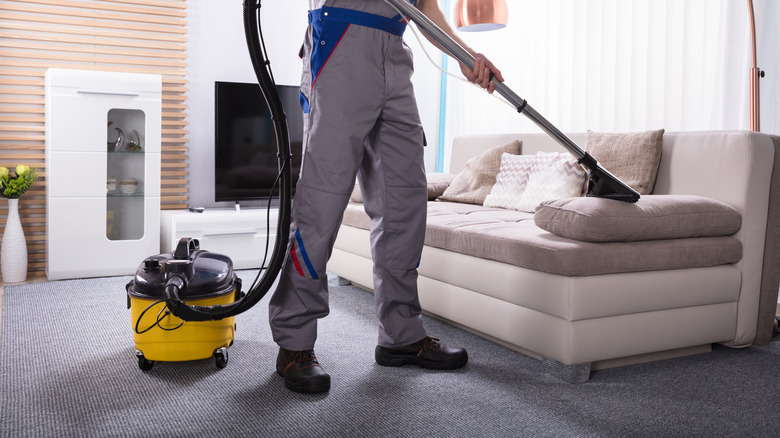 man cleaning couch