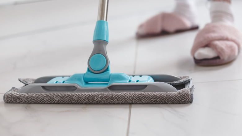 Close up of soft gray mop on tile floor