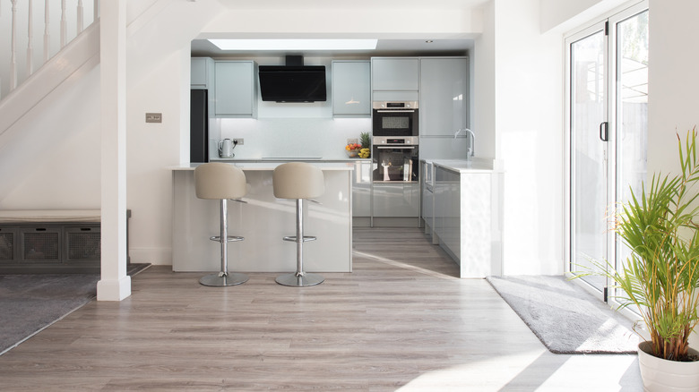 View of bright kitchen with clean pale gray vinyl flooring