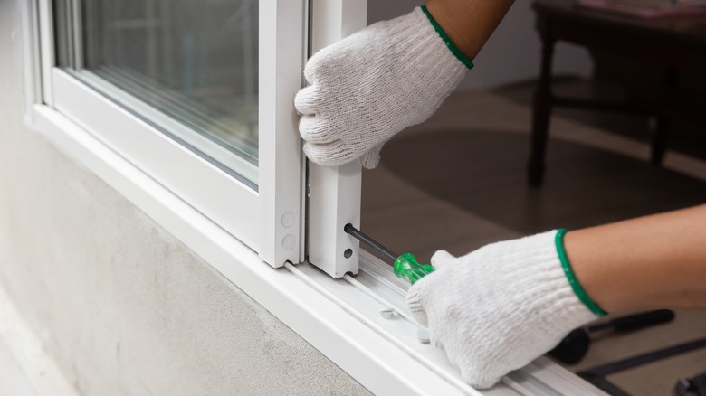 removing sliding door with screwdriver