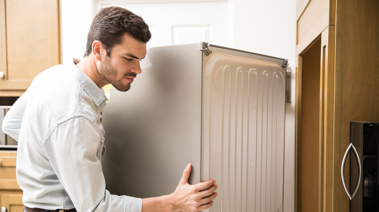 man moving a fridge 