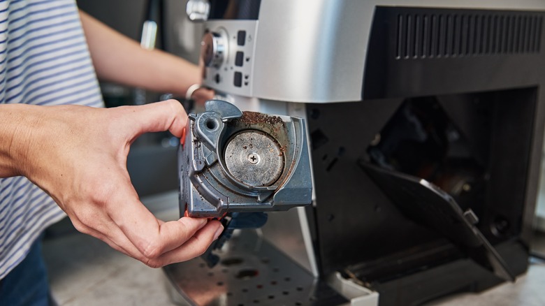 woman cleans coffee maker