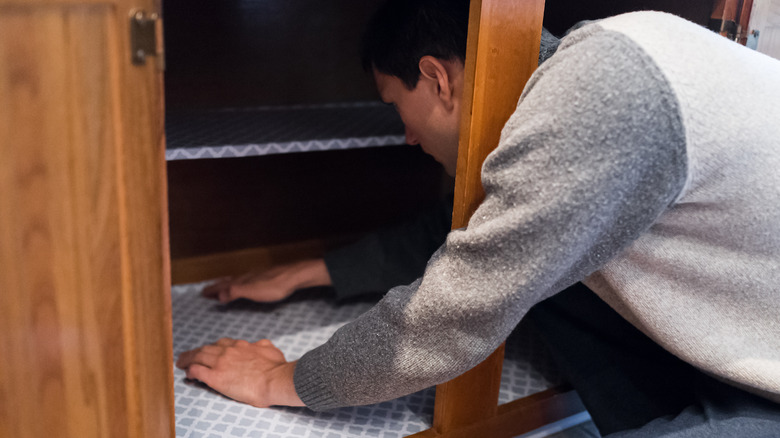 person placing cabinet liners