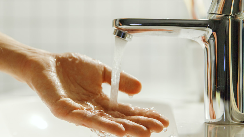 Hand testing water pressure