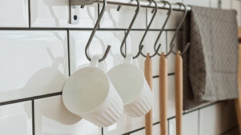 white mugs hanging on hooks