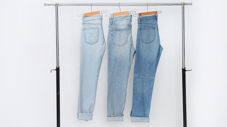 Jeans clipped hanging on rack