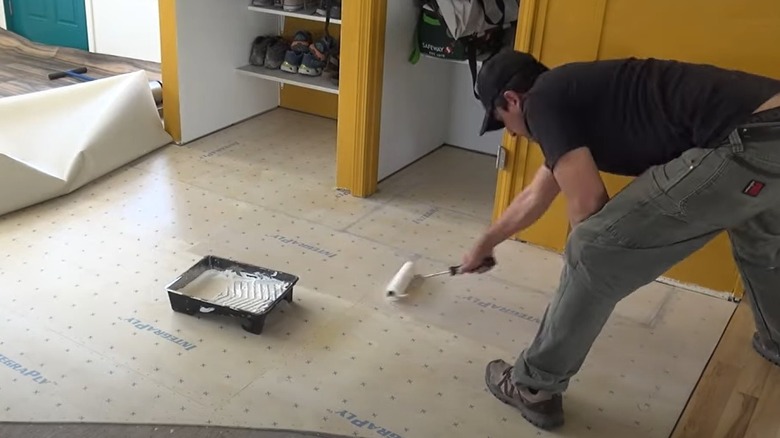 person applying flooring adhesive