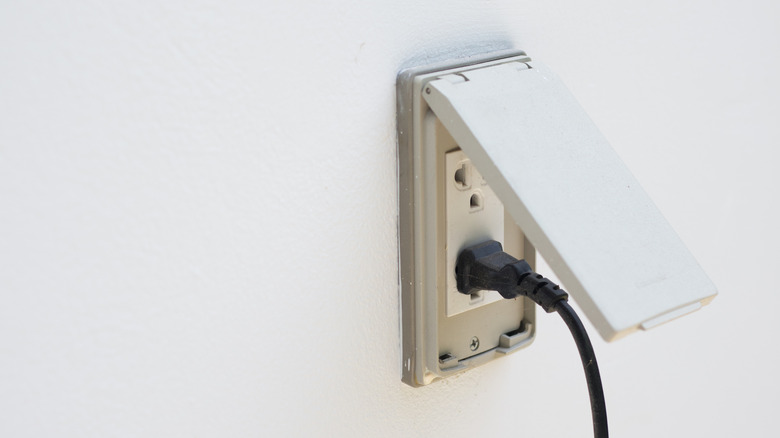 An outdoor electrical outlet with a cover