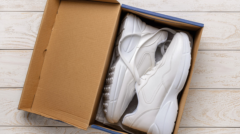 white sneakers in shoe box