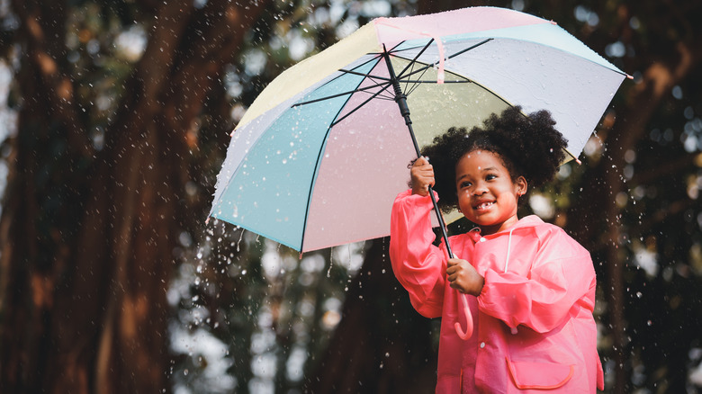 girl holding umbrella in rain