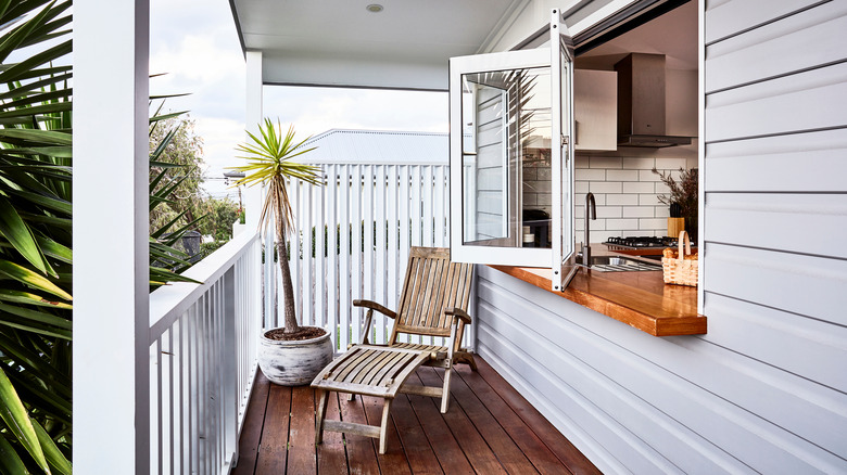 Wooden chaise on tiny porch