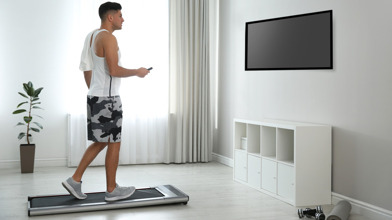 man working out with tv