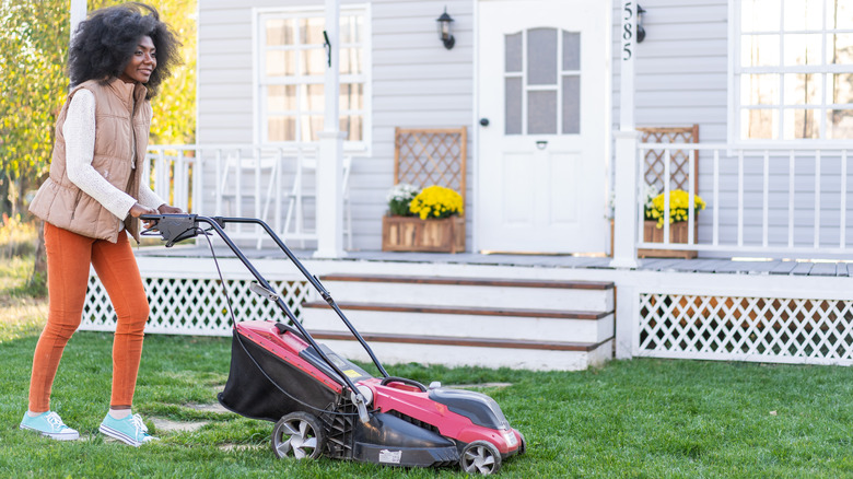 Black woman mowing neat lawn