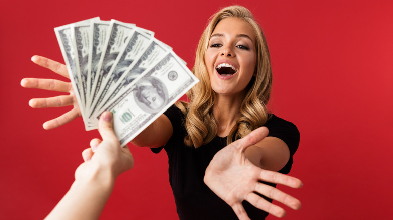 Woman reaching out for money