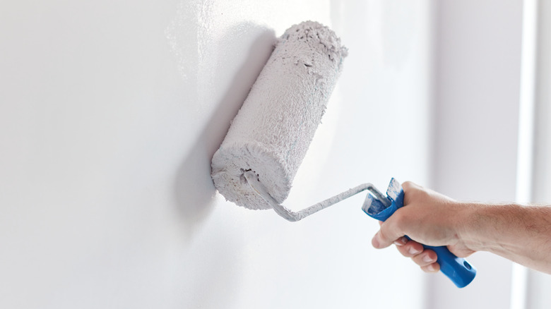 Hand holding paint roller