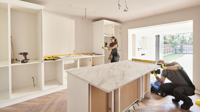 couple installing kitchen countertops