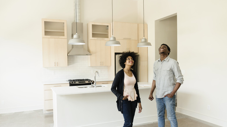 couple looking at a renovated kitchen