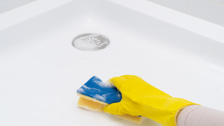 Person wiping down shower