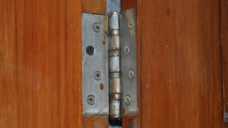 Old hinge on wood door