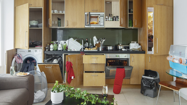 Several dirty and messy appliances in a kitchen