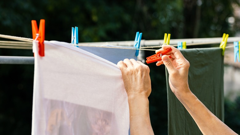 person air drying clothes outside