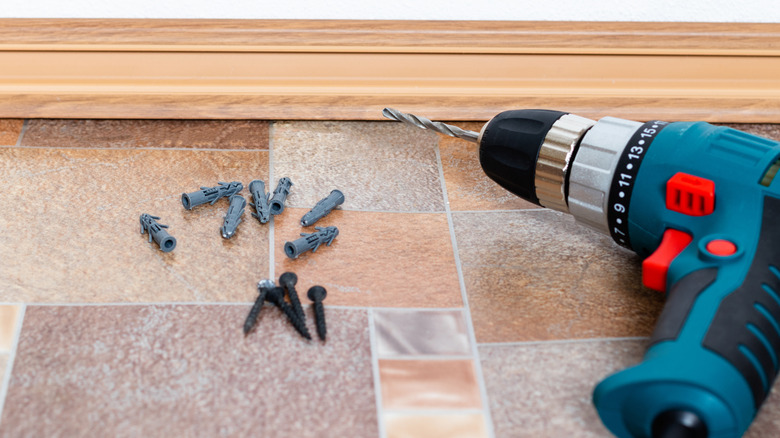 A piece of baseboard with the screws removed.