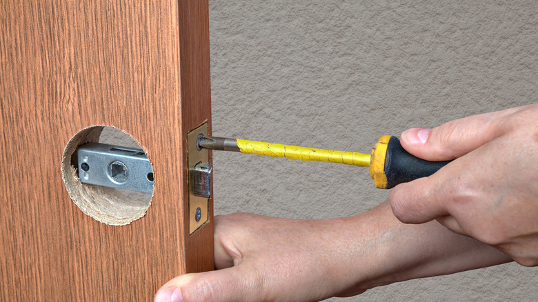 Person removing doorknob