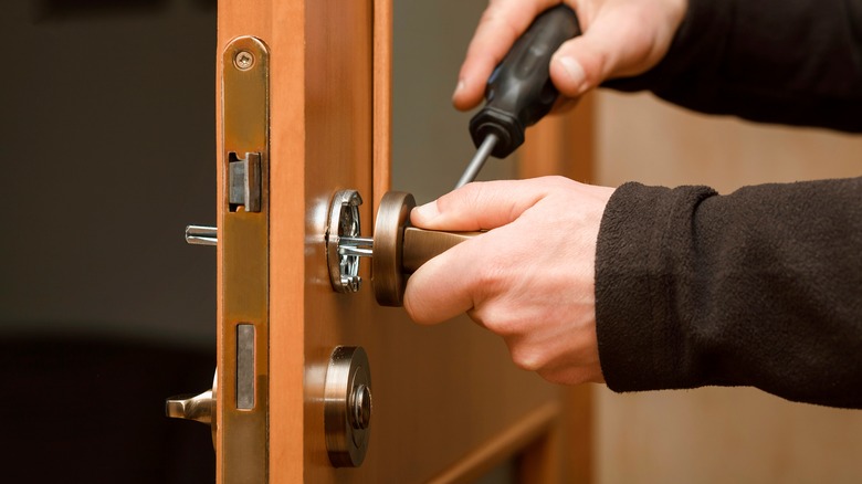 Person installing doorknob