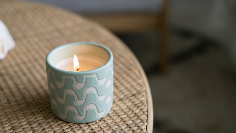 blue burning candle on table