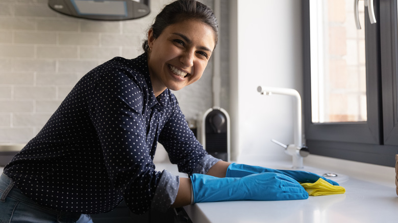 Someone cleaning kitchen countertop