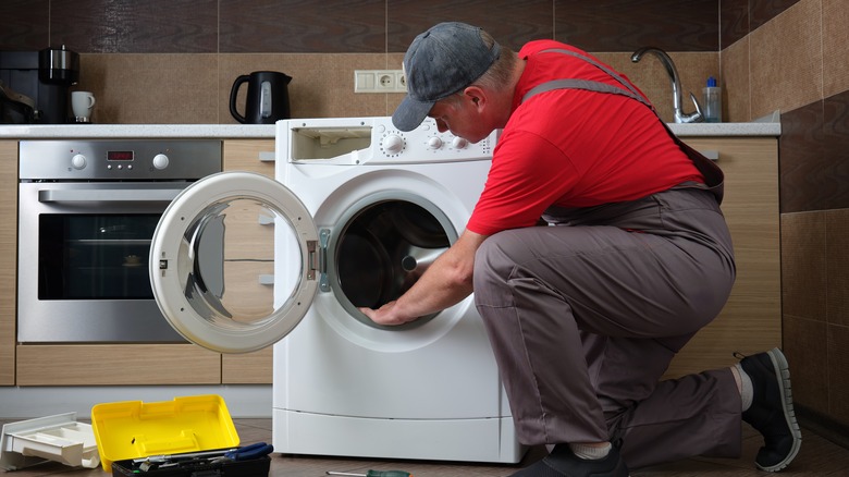 Person cleaning washing machine