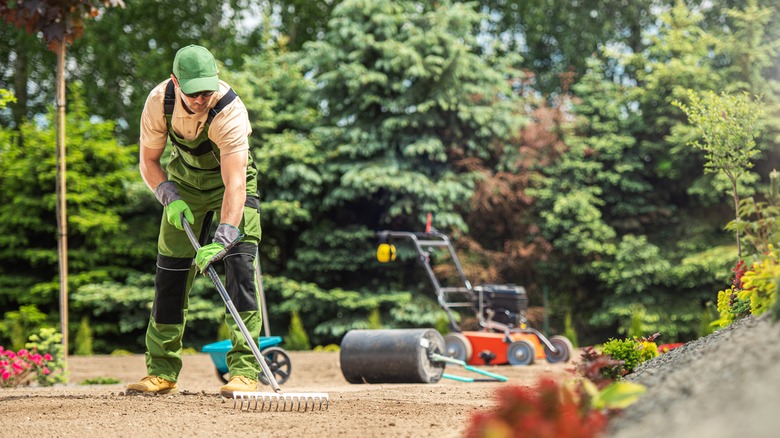 man cleaning yard