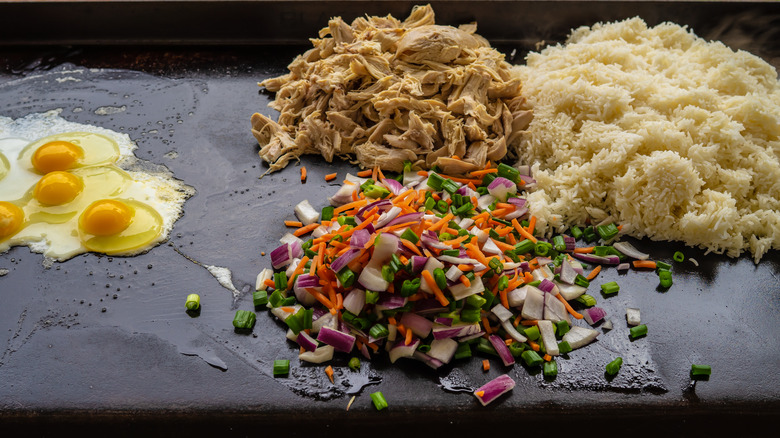 chicken fried rice ingredients on griddle 