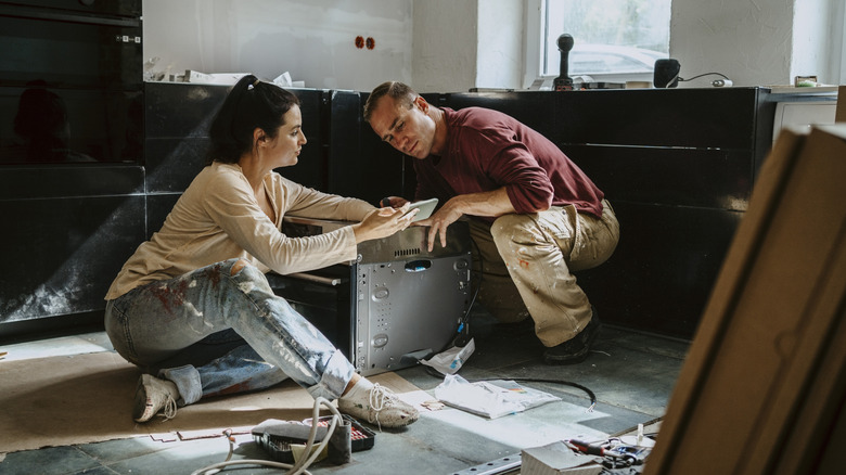 A couple working on renovating their ktichen