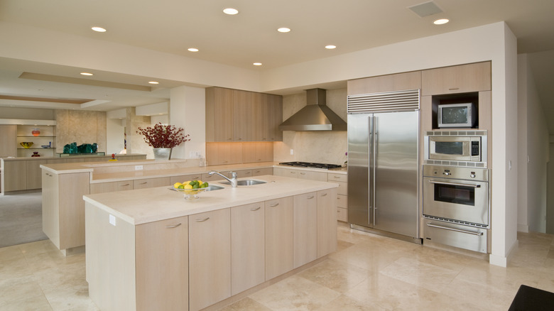 A kitchen with under-cabinet and recessed lighting