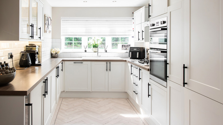 A kitchen with white cabinets