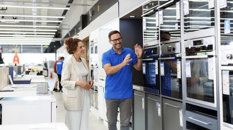 A woman shopping for a new oven