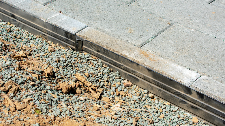 Edge restraints being used as paver edging material