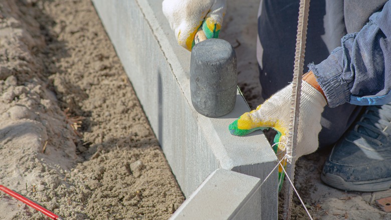 Man installing concrete edging