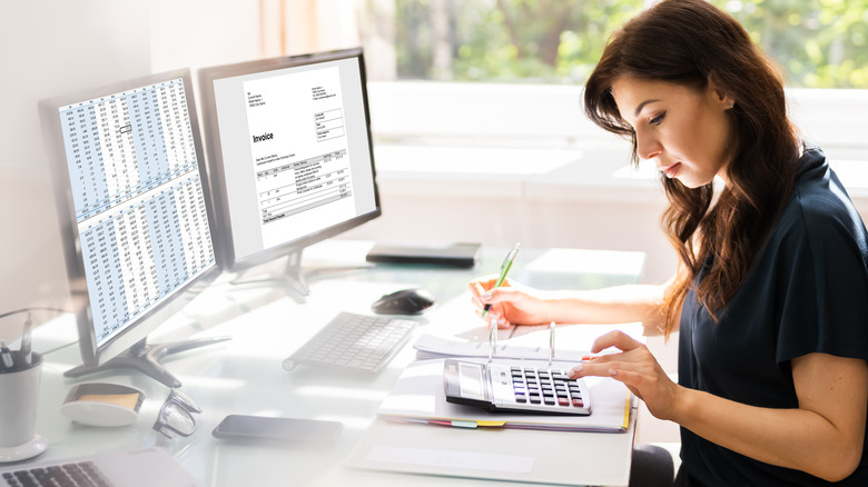 woman at desk with calculator