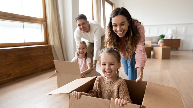 family pushing kids in boxes