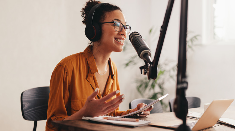 woman recording podcast at home