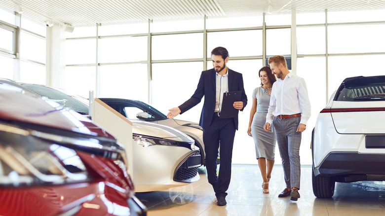 couple shopping at car dealership