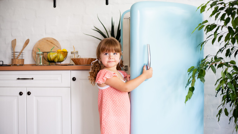 Girl with light turquoise refrigerator 